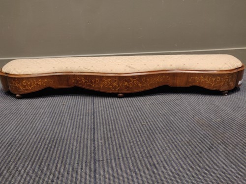 Lot 604 - An inlaid walnut footstool of serpentine form...