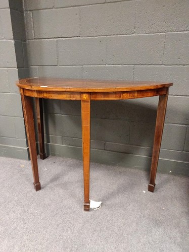 Lot 521 - An inlaid demi-lune console table raised on...