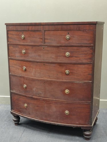 Lot 606 - An early 19th century tall mahogany bow front...