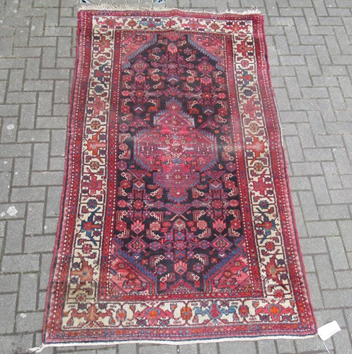 Lot 720 - A Hamadan rug with central medallion in reds...