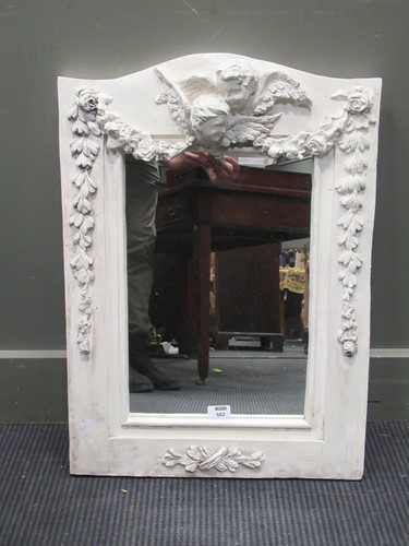 Lot 662 - A white painted wall mirror with putti and...