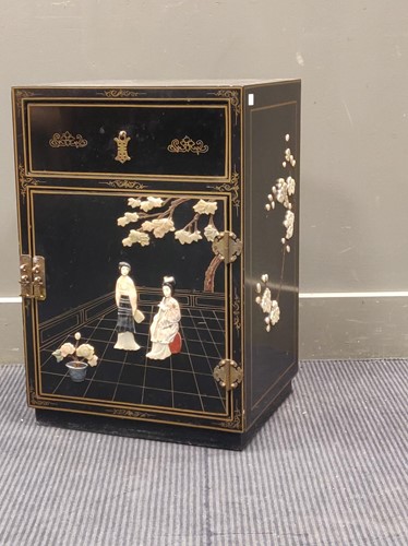 Lot 661 - A black lacquered small cabinet, 60 x 41 x 34cm
