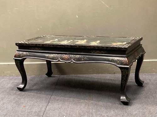 Lot 557 - A modern lacquered coffee table with a glazed...