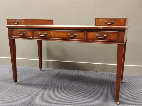 Lot 603 - A green leather topped desk on tapering square...