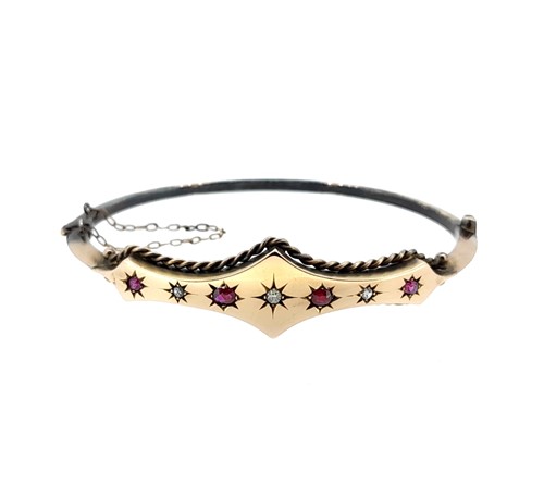 Lot 110 - A Victorian 9ct gold ruby and diamond bangle