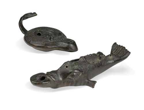 Lot 645 - A bronze oil lamp in the form of a dolphin, probably Pompeian period Roman, 1st-2nd century AD