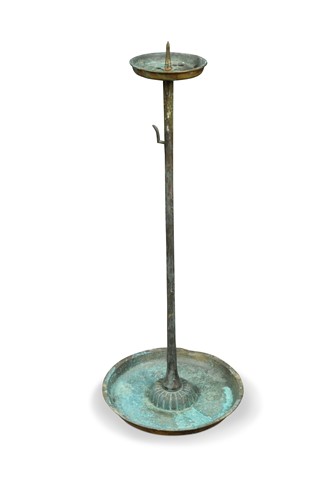 Lot 594 - A patinated brass pricket candlestick