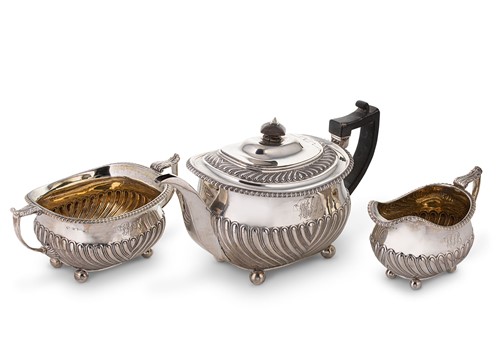 Lot 554 - A George III silver harlequin three-piece tea set