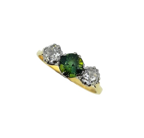 Lot 96 - A tourmaline and diamond three stone ring