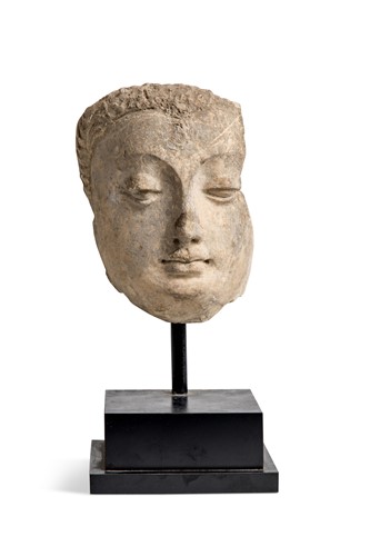 Lot 44 - A Gandharan stucco mask of a Buddhist devotee, 3rd-5th century