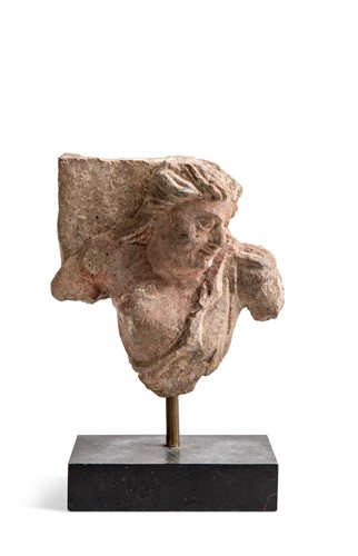 Lot 52 - A Gandharan painted schist bust of a Buddhist devotee, 3rd-5th century