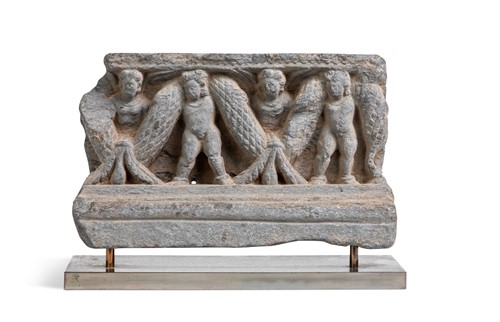 Lot 46 - A Gandharan grey schist garlanded putti stair riser, 1st-3rd century