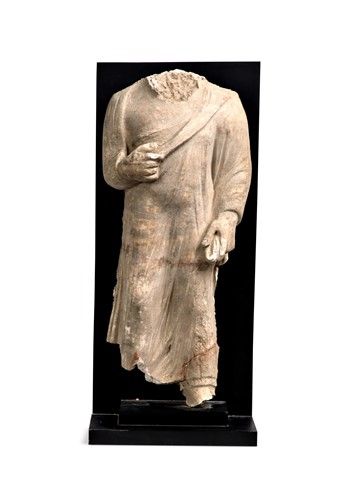 Lot 82 - A Gandharan large stucco torso of a Buddhist follower, 3rd-5th century