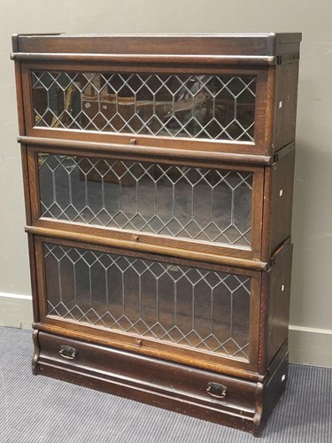Lot 598 - An oak Globe Werniker type three section...