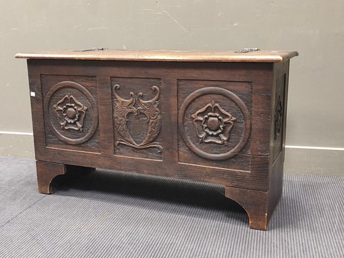 Lot 610 - A 20th century oak coffer with carved panel...