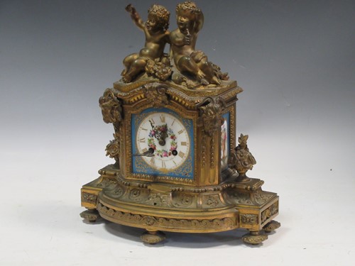 Lot 134 - A Louis XVI style mantel clock, with sevres...