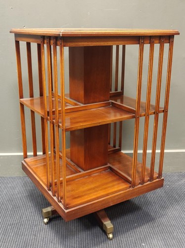 Lot 569 - An Edwardian mahogany square revoling bookcase...
