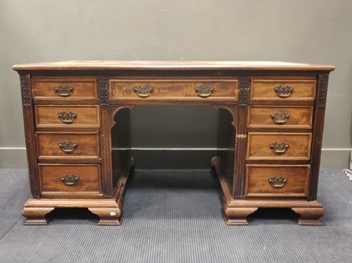 Lot 555 - An Edwardian mahogany pedistal desk, with...
