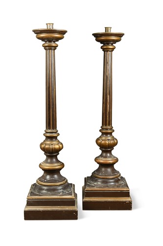 Lot 396 - A large pair of brown and gilt painted pricket candle stands, early 20th century