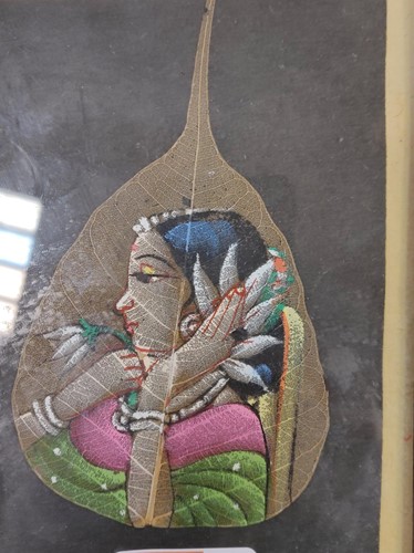 Lot 387 - A Modern Indian painting of a woman holding a...