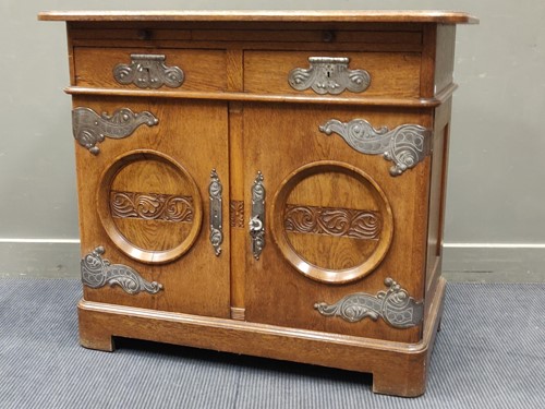 Lot 559 - An oak German or Austrian side cabinet, with...