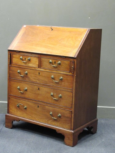 Lot 515 - A George III mahogany bureau, the fall front...