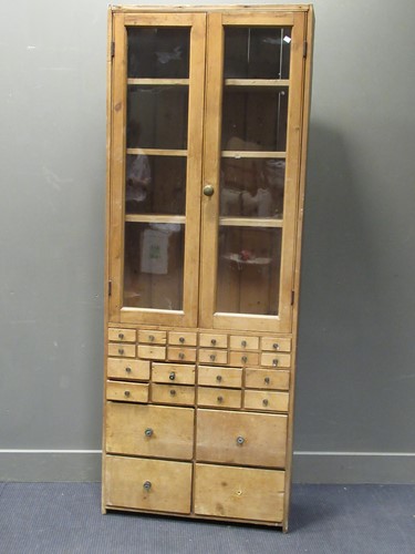 Lot 601 - A pine glazed cabinet, the two glazed doors...