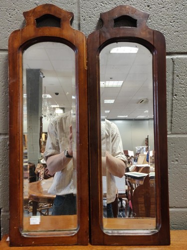Lot 633 - A pair of hanging mahogany shaped mirrors,...
