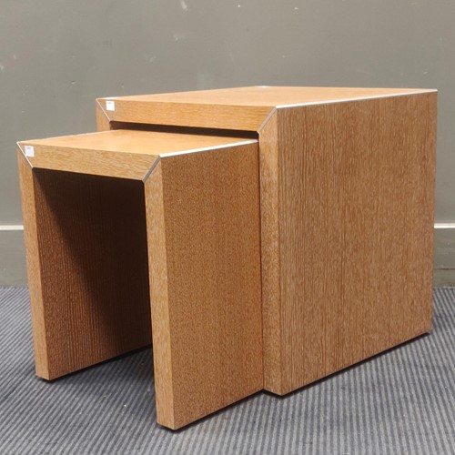Lot 574 - A modern nest of two blonde oak tables with...