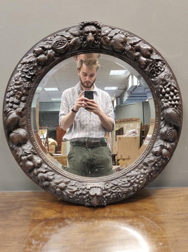 Lot 567 - A Black Forest circular wall mirror circa 1900,...
