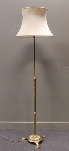 Lot 527 - A brass adjustable standard lamp on tripod...