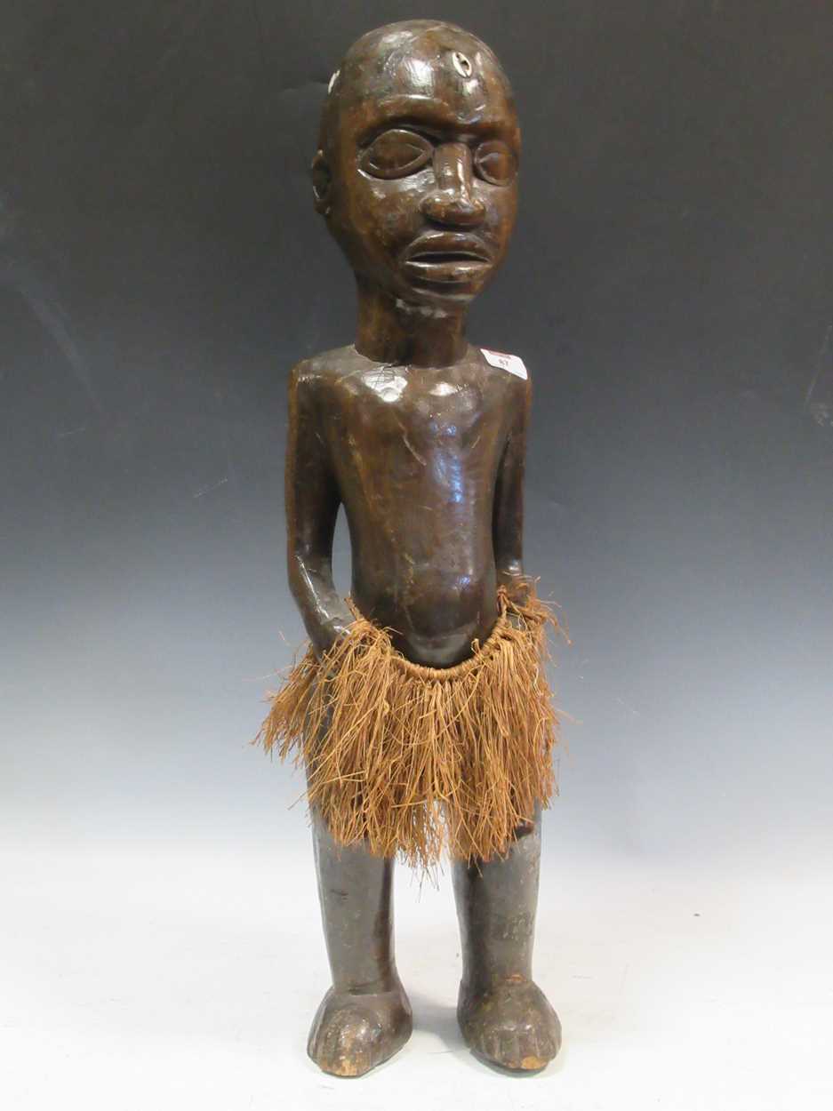 Lot 87 - A carved wood tribal figure of a man 74cm