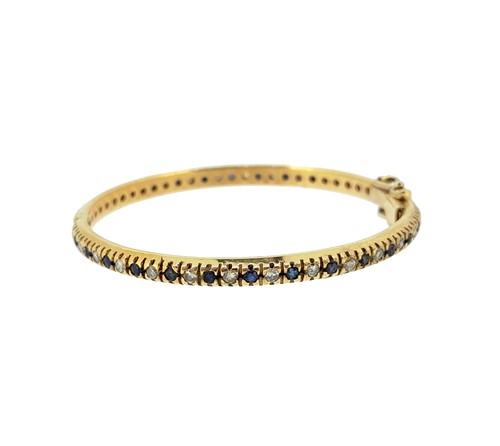 Lot 40 - A sapphire and diamond child's bangle