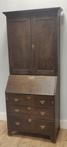 Lot 609 - An 18th century and later oak bureau cabinet,...