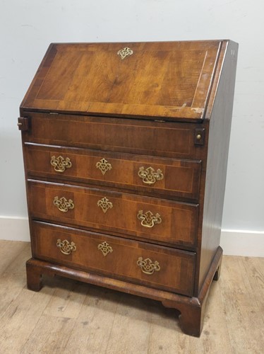 Lot 516 - An 18th century and later inlaid walnut bureau,...