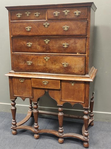 Lot 565 - An 18th century walnut and oak chest on stand,...