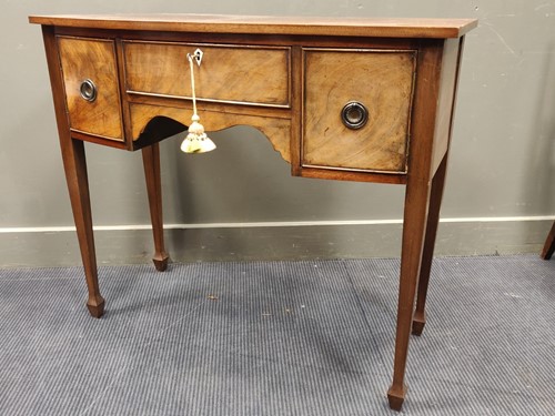 Lot 568 - A mahogany bowfront sideboard with tapered...