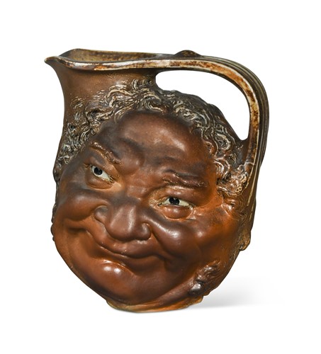 Lot 44 - Robert Wallace Martin for Martin Brothers, a stoneware face jug, 1899