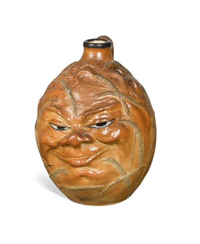 Lot 43 - Robert Wallace Martin for Martin Brothers, a stoneware John Barleycorn face jug, 1910