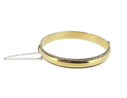 Lot 127 - A 9ct gold hinged bangle