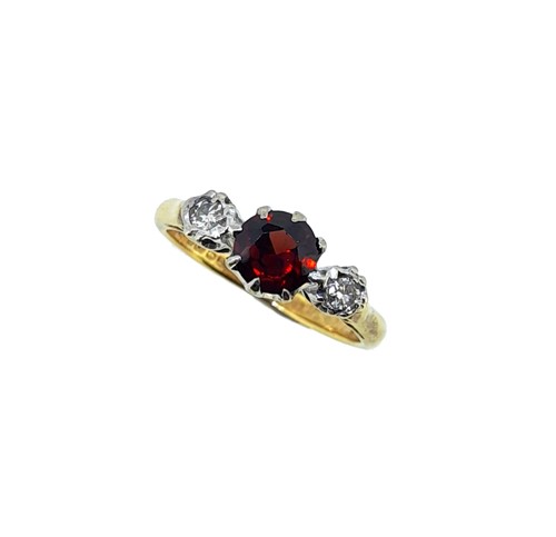 Lot 57 - An 18ct gold garnet and diamond three stone ring