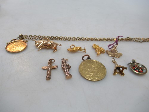 Lot 234 - six assorted charms assessed as gold, gross...