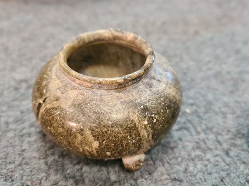 Lot 91 - A Chinese green puddingstone tripod small vase, perhaps Tang Dynasty