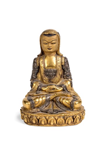 Lot 135 - A Tibetan gilt bronze seated figure of a lama, early/mid 20th century