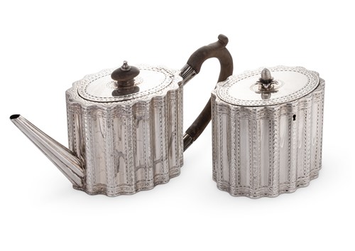Lot 560 - A George III 18th century silver teapot and accompanying tea caddy