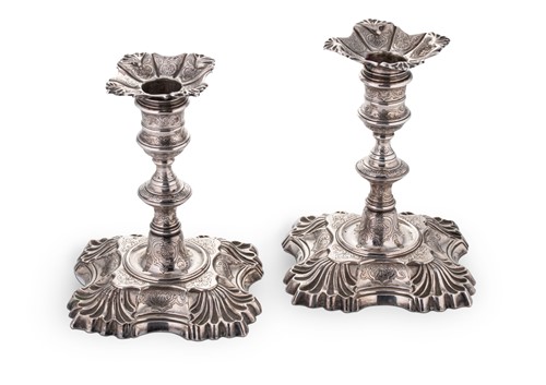 Lot 527 - A pair of George II cast silver library candlesticks
