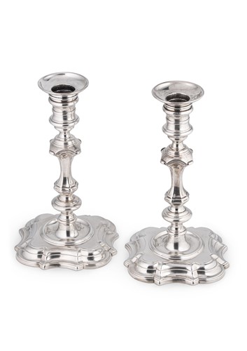 Lot 533 - A pair of George II cast silver candlesticks, mark of George Wickes