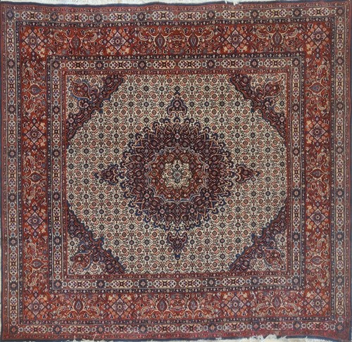 Lot 603 - A Tabriz style pale ground rug with central...
