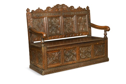 Lot 134 - A later carved oak box-seated settle, 19th century