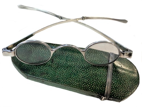 Lot 438 - A shagreen case containing a pair of George IV silver framed spectacles